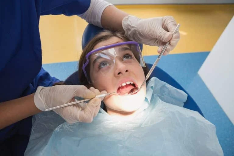 young patient wearing safety glasses examination